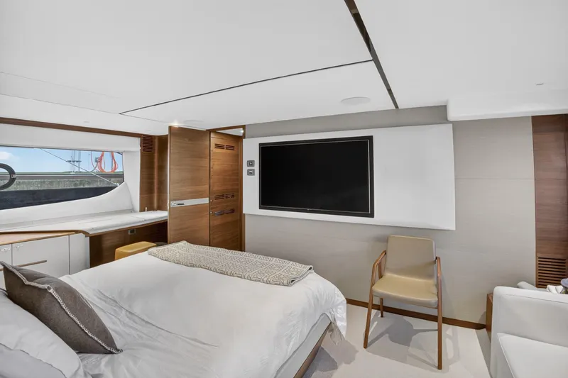 Slide: The Image of Luxurious 2022 Princess Y85 yacht bedroom with modern decor and large TV. - 49