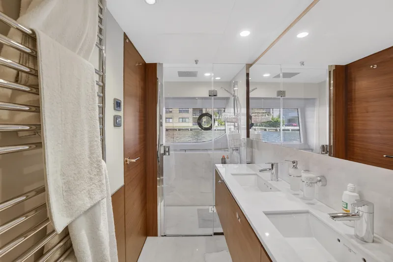 Slide: The Image of Luxurious bathroom interior on 2022 Princess Y85 yacht, featuring dual sinks and glass shower. - 52