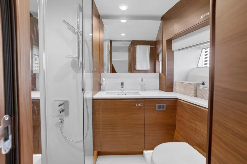 Slide: The Image of Luxurious 2022 Princess Y85 yacht bathroom with modern wood cabinetry and sleek fixtures. - 63