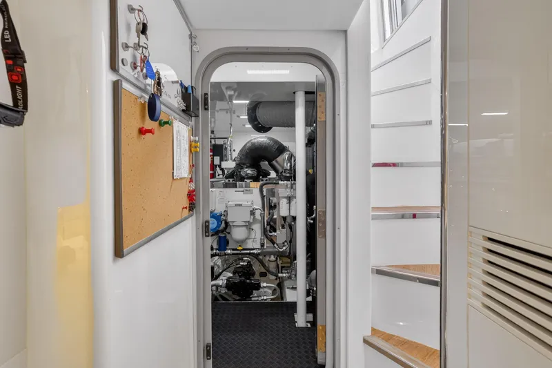 Slide: The Image of Engine room entrance of 2022 Princess Y85 yacht, featuring control panels and equipment. - 68