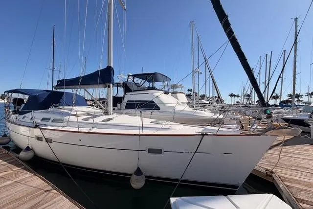 The Image of 2005 Beneteau Oceanis Clipper 423 sailboat docked at marina under clear blue sky. - 0