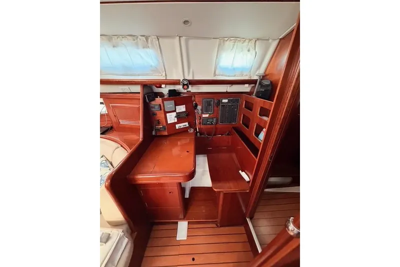 Slide: The Image of 2005 Beneteau Oceanis Clipper 423 interior navigation station with wood finish. - 11