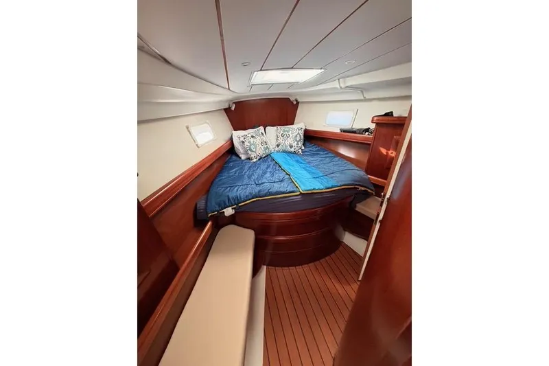 Slide: The Image of Cozy cabin interior of 2005 Beneteau Oceanis Clipper 423 with wooden finish and bedding. - 15