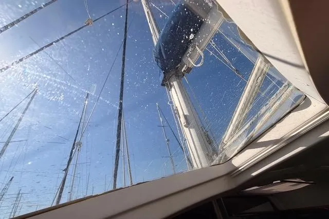 Slide: The Image of View from Beneteau Oceanis Clipper 423 sailboat, showcasing mast and clear blue sky. - 16