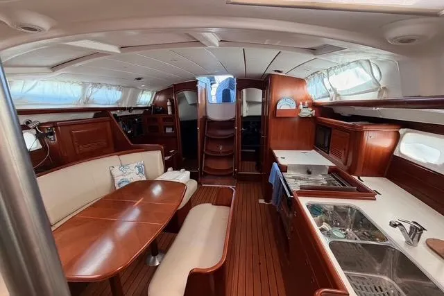 Slide: The Image of Interior of 2005 Beneteau Oceanis Clipper 423 yacht with wood finish and dining area. - 7