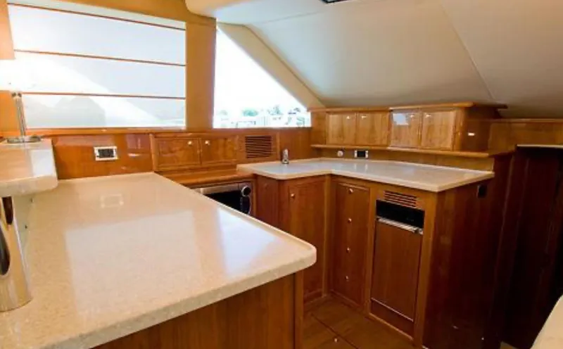 Slide: The Image of Luxurious kitchen interior of 2009 Riviera 47 Enclosed Flybridge Series II yacht. - 13