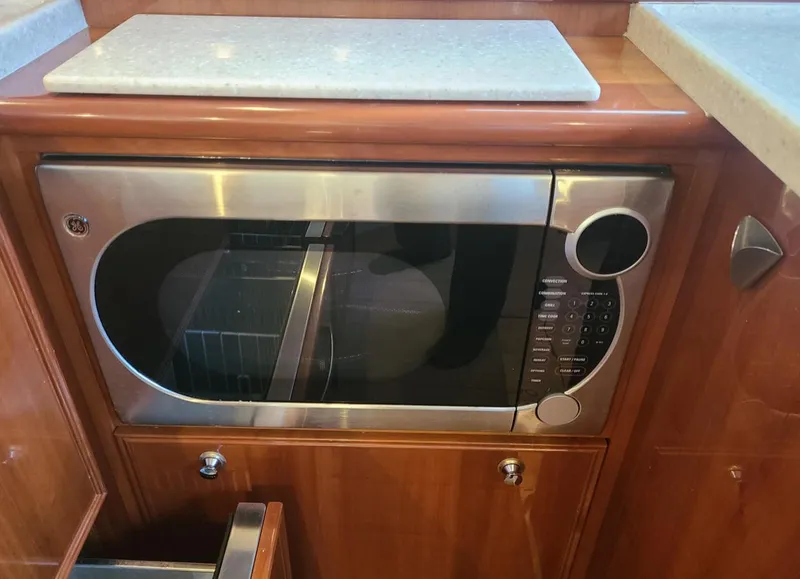 Slide: The Image of Microwave in 2009 Riviera 47 Enclosed Flybridge Series II yacht kitchen. - 18
