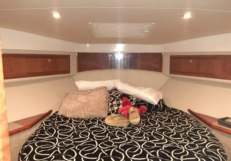 Slide: The Image of Cozy bedroom in 2009 Riviera 47 Enclosed Flybridge Series II yacht with patterned bedding. - 25