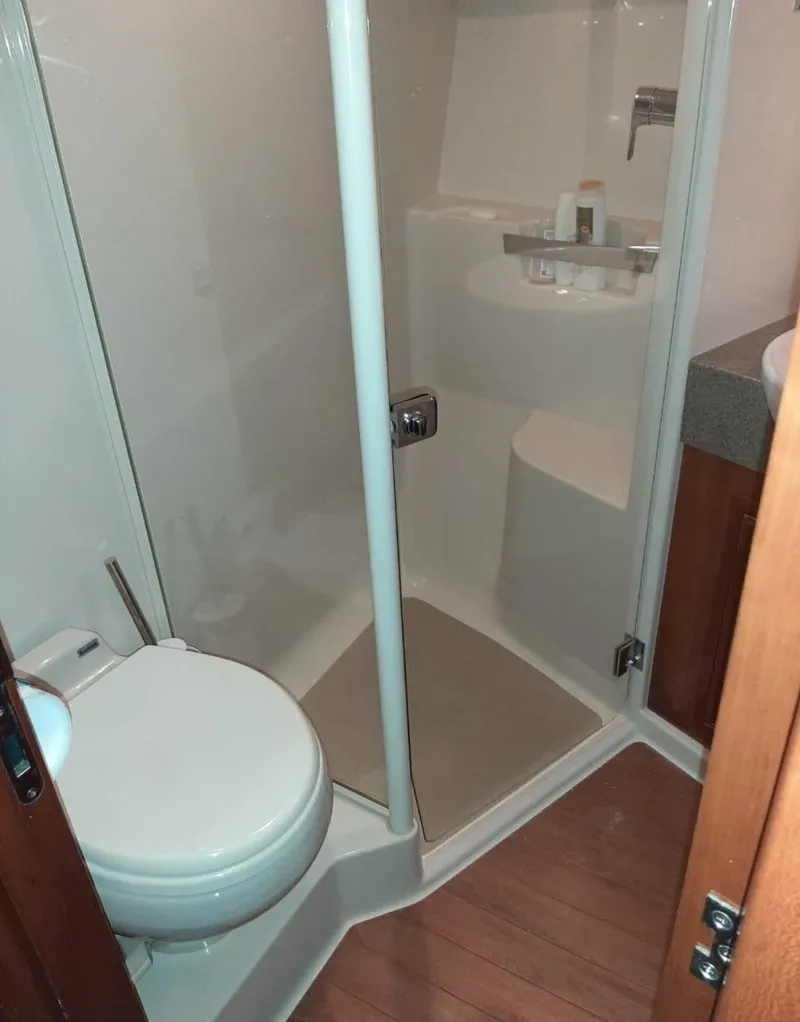 Slide: The Image of 2009 Riviera 47 Enclosed Flybridge Series II bathroom with shower and toilet. - 29