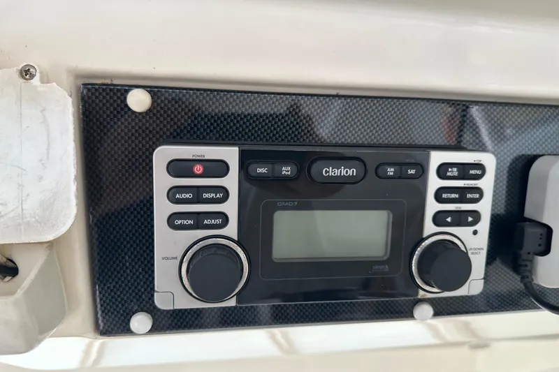 Slide: The Image of Clarion audio system on 2009 Riviera 47 Enclosed Flybridge Series II yacht dashboard. - 40