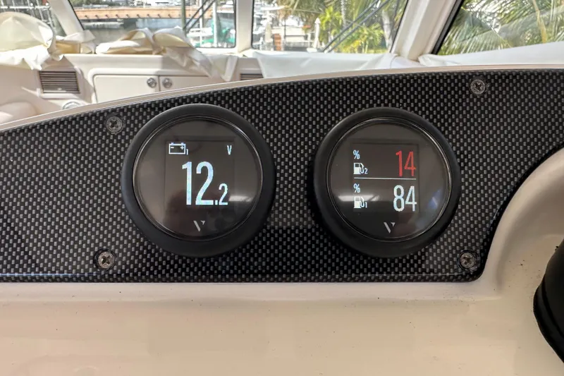 Slide: The Image of Dashboard of 2009 Riviera 47 Enclosed Flybridge Series II with voltage and fuel gauges. - 44