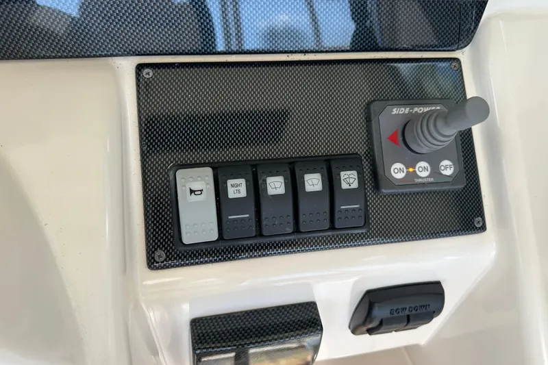 Slide: The Image of Control panel of 2009 Riviera 47 Enclosed Flybridge Series II with switches and joystick. - 54