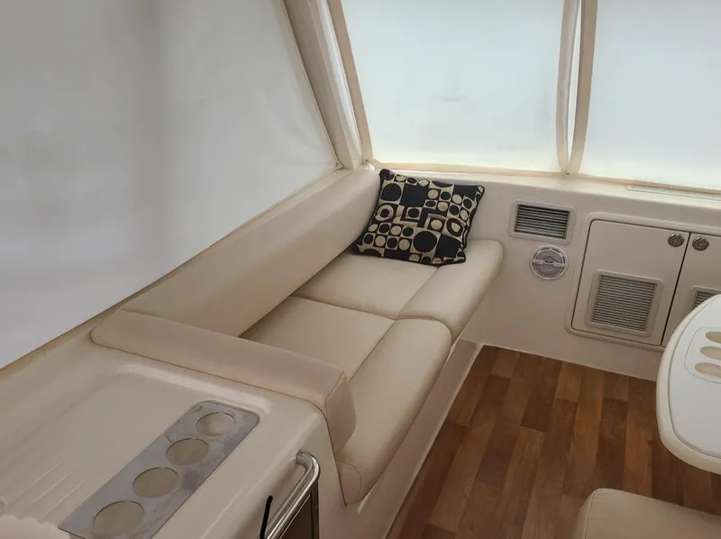 Slide: The Image of Luxurious interior of 2009 Riviera 47 Enclosed Flybridge Series II with beige seating and patterned cushion. - 60
