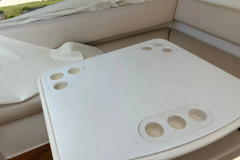 Slide: The Image of White table with cup holders on a 2009 Riviera 47 Enclosed Flybridge Series II yacht. - 64