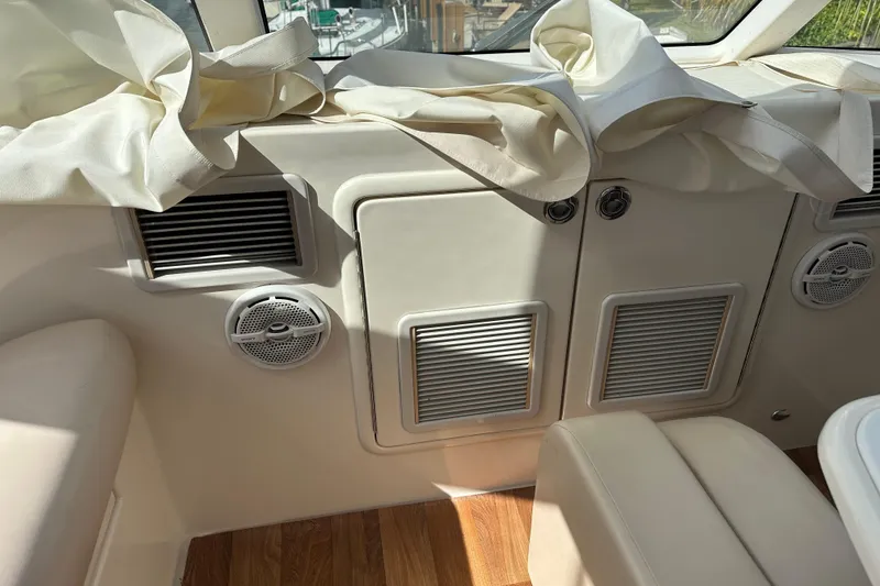 Slide: The Image of Interior of 2009 Riviera 47 Enclosed Flybridge Series II with beige upholstery and wood flooring. - 67