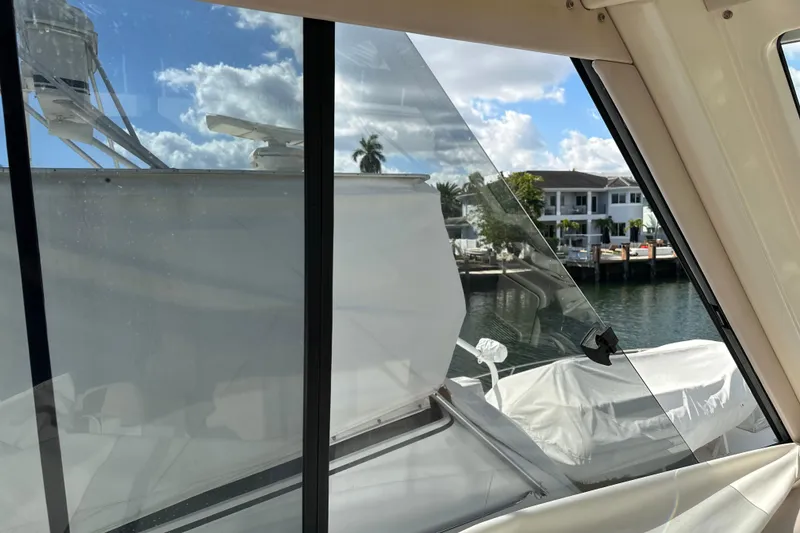 Slide: The Image of View from 2009 Riviera 47 Enclosed Flybridge Series II, overlooking marina and waterfront homes. - 69