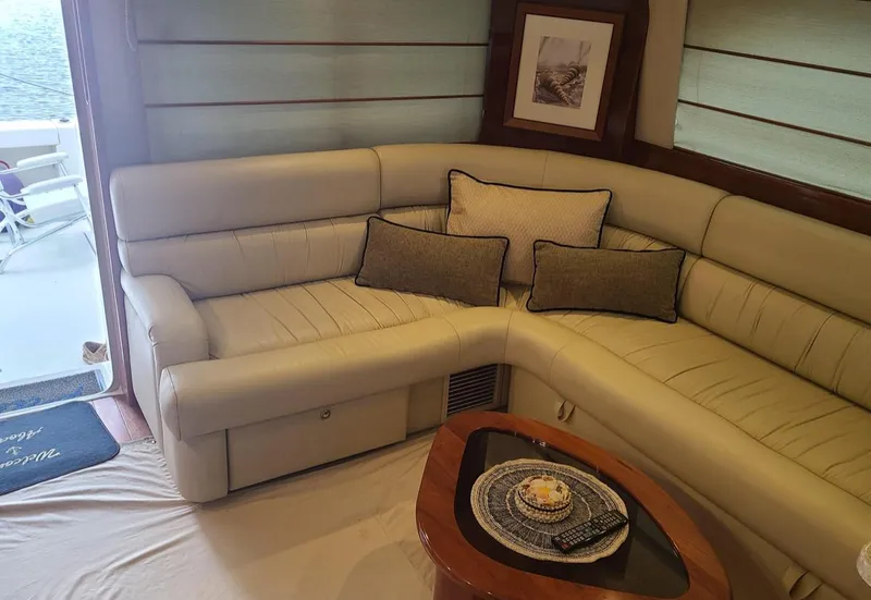 Slide: The Image of Luxurious interior of 2009 Riviera 47 Enclosed Flybridge yacht with plush seating and elegant decor. - 8