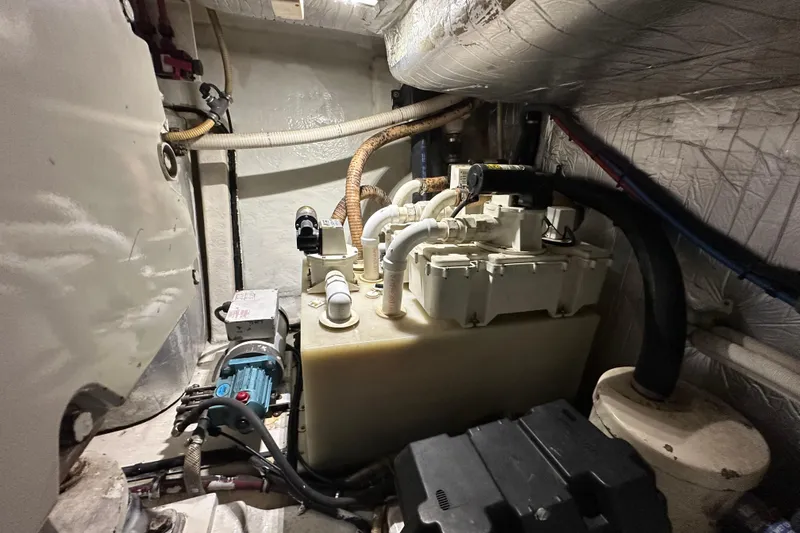 Slide: The Image of Engine room of 2009 Riviera 47 Enclosed Flybridge Series II with mechanical components. - 83