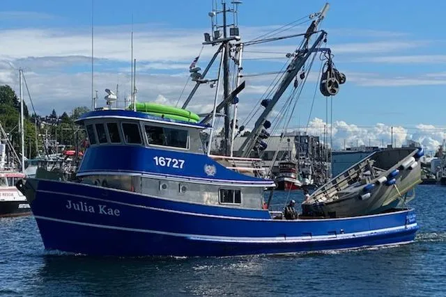 The Image of Blue 1973 Custom 58’ Steel Marco Seiner fishing boat on water, sunny day. - 0