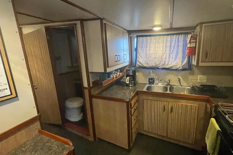 Slide: The Image of Interior of 1973 Custom 58’ Steel Marco Seiner with kitchen and bathroom. - 10