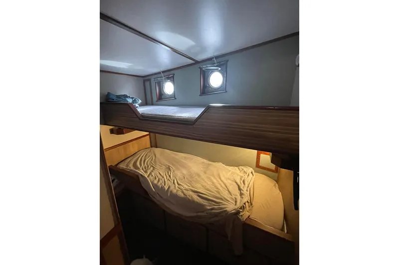 Slide: The Image of Cozy bunk beds in 1973 Custom 58’ Steel Marco Seiner cabin with porthole windows. - 13