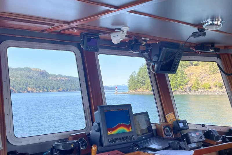 Slide: The Image of Bridge view from 1973 Custom 58’ Steel Marco Seiner, overlooking scenic coastal waters. - 2