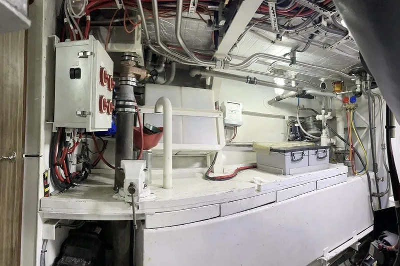 Slide: The Image of Engine room of a 1973 Custom 58’ Steel Marco Seiner with electrical panels and piping. - 25