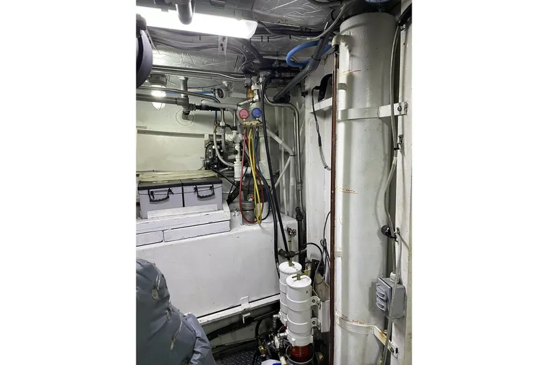 Slide: The Image of Engine room of a 1973 Custom 58’ Steel Marco Seiner with visible pipes and equipment. - 26