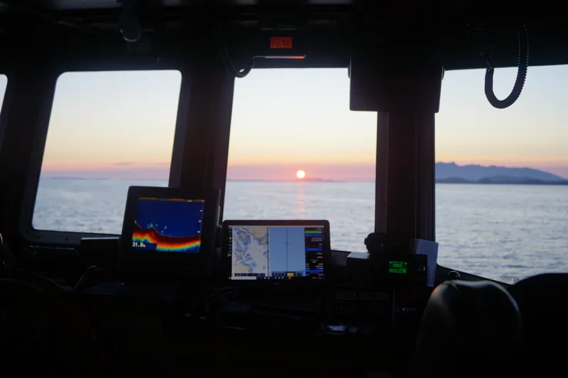 Slide: The Image of Interior view of 1973 Custom 58’ Steel Marco Seiner, sunset over ocean horizon. - 3