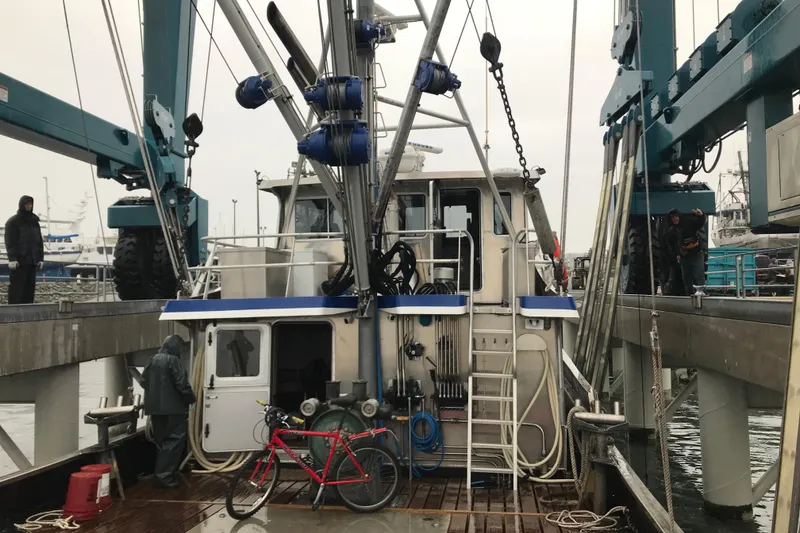 Slide: The Image of 1973 Custom 58’ Steel Marco Seiner docked, featuring fishing equipment and a red bicycle. - 32