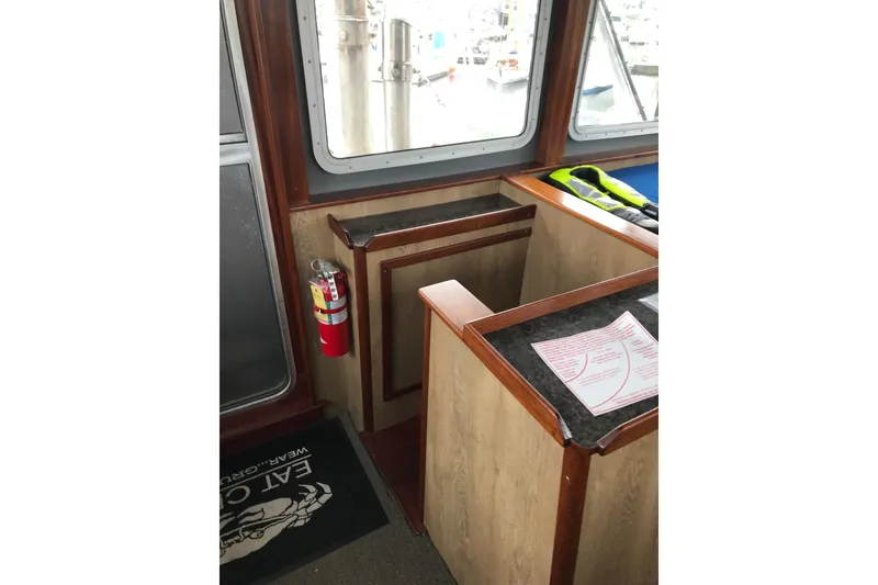 Slide: The Image of Interior of 1973 Custom 58’ Steel Marco Seiner with safety equipment and nautical decor. - 36