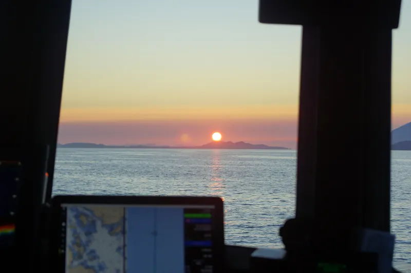 Slide: The Image of Sunset view from 1973 Custom 58’ Steel Marco Seiner, with navigation equipment visible. - 4