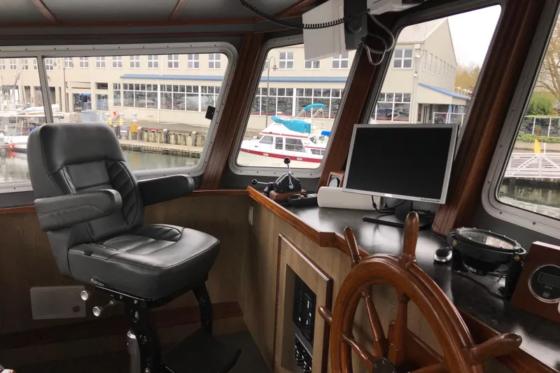 Slide: The Image of Interior of 1973 Custom 58’ Steel Marco Seiner with helm, chair, and navigation equipment. - 5