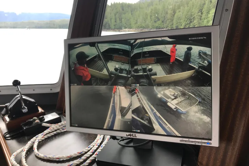Slide: The Image of Monitor displaying security camera footage on a 58’ Steel Marco Seiner, 1973 model, in a scenic waterway. - 6