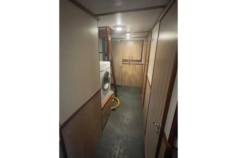 Slide: The Image of Interior of 1973 Custom 58’ Steel Marco Seiner with washer and wood paneling. - 9