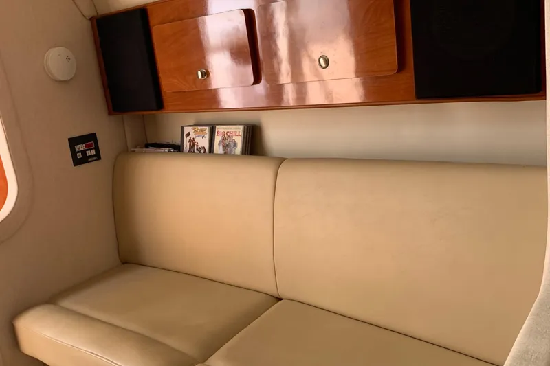 Slide: The Image of Interior of 2006 Rinker Fiesta Vee 300 yacht with leather sofa and wooden cabinets. - 12