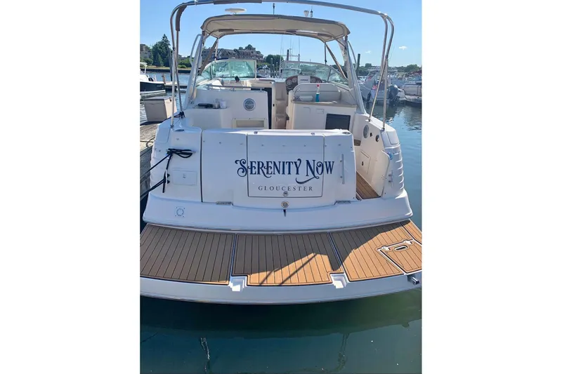 Slide: The Image of 2006 Rinker Fiesta Vee 300 boat docked, named "Serenity Now," in Gloucester marina. - 19