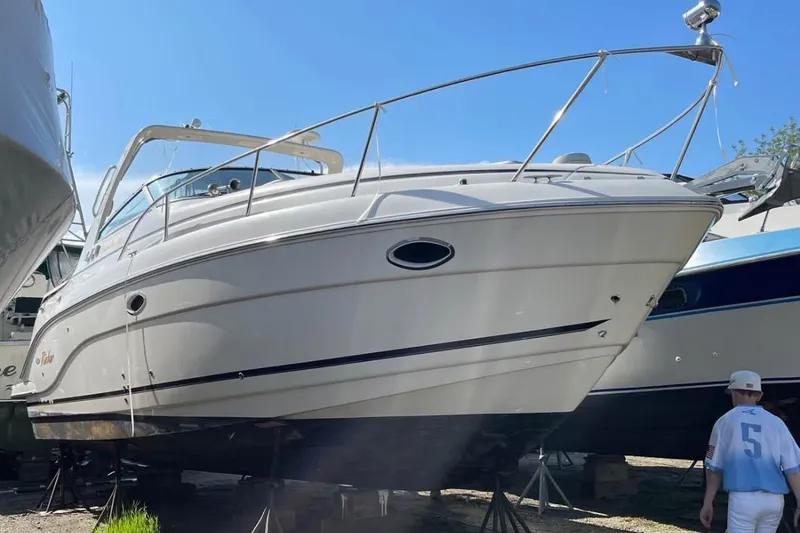 Slide: The Image of 2006 Rinker Fiesta Vee 300 boat on dry dock under clear blue sky. - 26