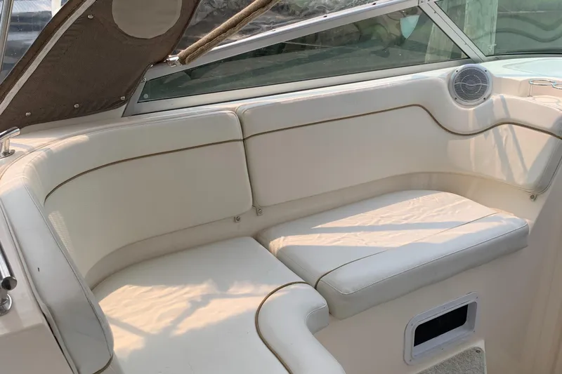 Slide: The Image of Interior of a 2006 Rinker Fiesta Vee 300 with white upholstery. - 12