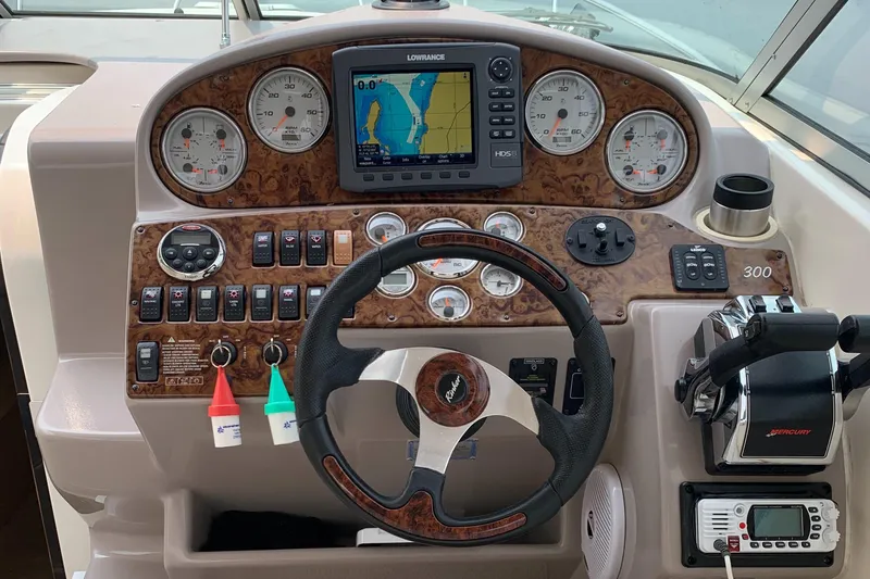 Slide: The Image of 2006 Rinker Fiesta Vee 300 helm with navigation system. - 13