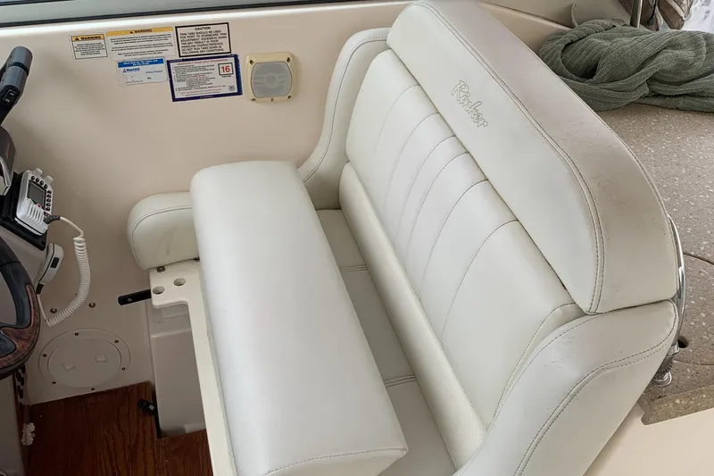 Slide: The Image of Interior of a 2006 Rinker Fiesta Vee 300 boat with white seating. - 5