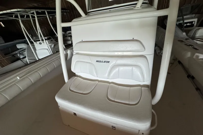 Slide: The Image of Interior view of a 2014 Regulator 28 boat with white seating. - 10
