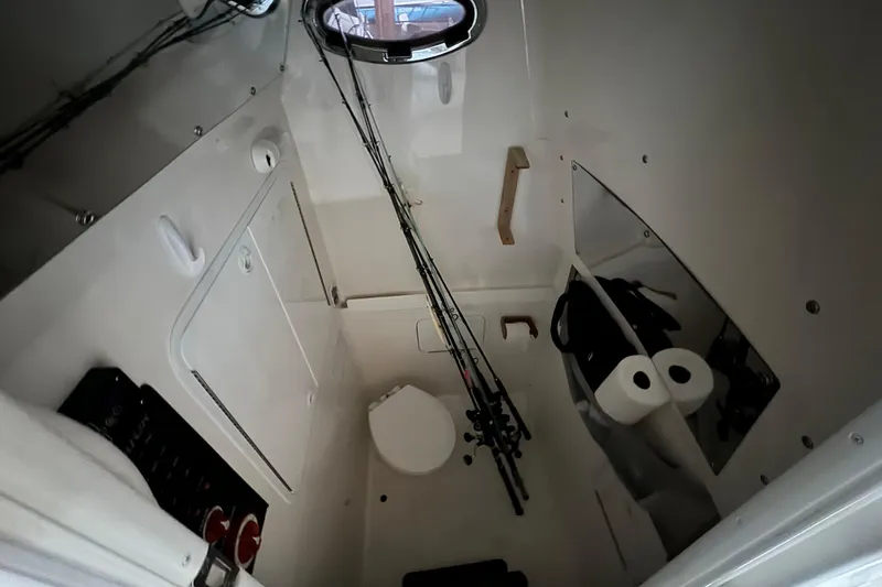 Slide: The Image of Interior of a 2014 Regulator 28 boat with fishing rods and toilet. - 11