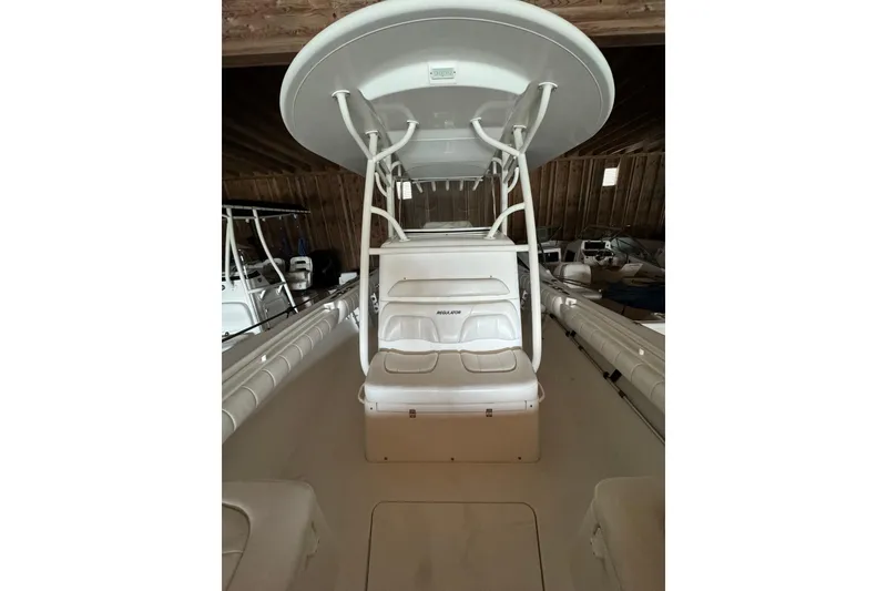 Slide: The Image of Interior view of a 2014 Regulator 28 boat in a storage shed. - 8