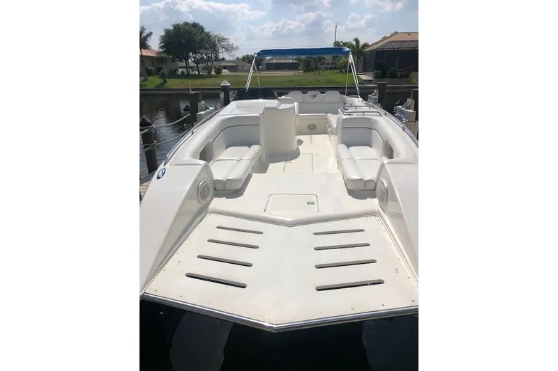 Slide: The Image of 2005 Conquest Top Cat boat with spacious seating, docked by a serene waterfront. - 7