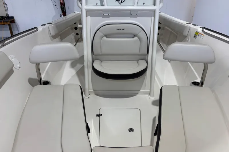 Slide: The Image of 2024 Sailfish 242 CC boat interior with white seating and storage compartments. - 10