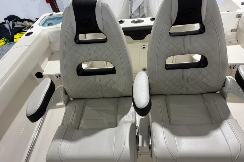 Slide: The Image of 2024 Sailfish 242 CC boat seats with quilted design and armrests. - 15