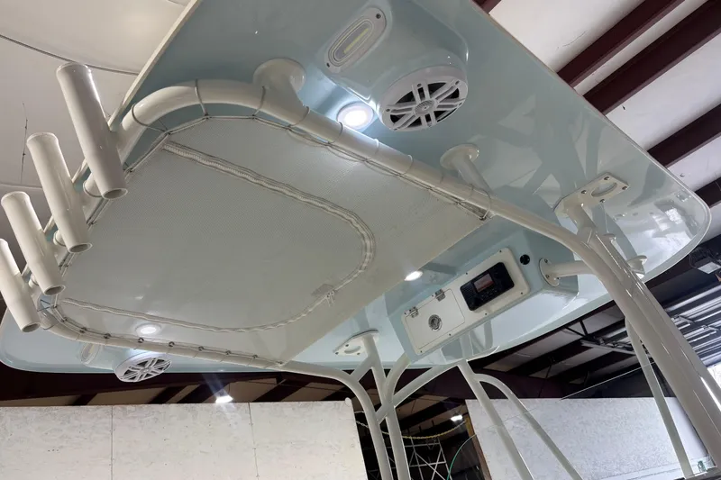 Slide: The Image of 2024 Sailfish 242 CC boat's overhead view with rod holders and speakers. - 17