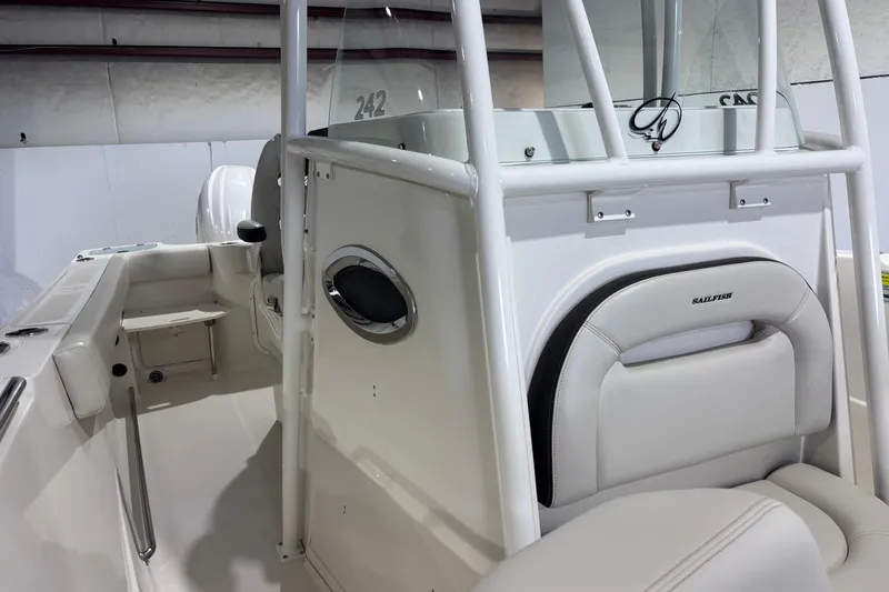 Slide: The Image of 2024 Sailfish 242 CC boat interior with white seating and console details. - 19
