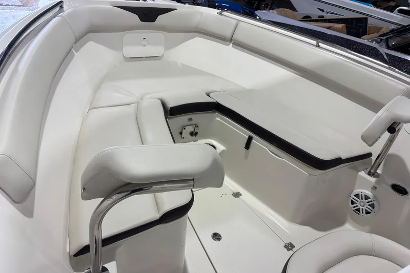 Slide: The Image of 2024 Sailfish 242 CC boat interior with white seating and storage compartments. - 24
